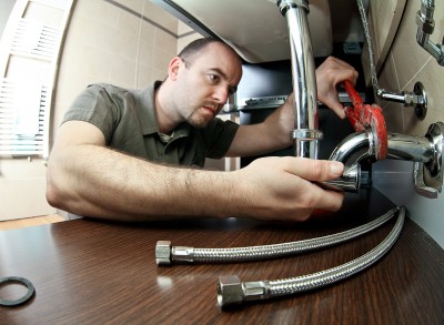 Stockton plumber tightens a drain pipe
